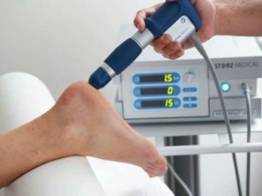 A fascite plantar é a causa mais comum de dor na região plantar do calcanhar. É uma síndrome dolorosa definida como uma sobrecarga de tensão da fáscia plantar em sua origem no tubérculo medial do calcâneo. Geralmente, os sintomas começam como uma dor intermitente que, na maioria das vezes, progride para uma dor aguda e persistente. 

Os sintomas incluem dor com os primeiros passos da manhã ou após o períodos de repouso prolongado. A dor é agravada pela sobrecarga contínua, e se torna progressivamente mais intensa. Seu início é insidioso e nem sempre associado a um incidente ou trauma específico. 

Cargas excessivas não formam uma ruptura no ponto médio da fáscia plantar, mas criam uma resposta inflamatória local na inserção do calcâneo. Além disso, degeneração, microfissuras e fibrose também podem ocorrer.

Tratamento por ondas de choque
Nos últimos 20 anos, as ondas de choque extracorpóreas têm sido usadas para tratar de forma segura e eficaz uma série de patologias. A terapia por ondas de choque é usada na ortopedia, medicina esportiva e fisiatria para várias patologias, como tendinopatias insercionais, tendinite calcificante do ombro, epicondilite lateral, bursite trocanteriana e fascite plantar.

O mecanismo exato pelo qual as ondas de choque funcionam para tratar doenças musculoesqueléticas não é conhecido. Acredita-se que o tratamento cause danos teciduais locais e controlados, que levam à neovascularização e aumento das quantidades de fatores locais de crescimento tecidual local.

Em uma revisão da literatura atual publicada sobre o uso da terapia por ondas de choque para o tratamento da fascite plantar, vários ensaios clínicos foram encontrados, com uma taxa de sucesso variando de 34% a 88%. Porém, muitos estudos não foram adequadamente controlados com um tratamento sham.

Vários estudos compararam o efeito das ondas de choque com cirurgia, injeção de corticosteroide local ou fisioterapia no tratamento da fascite plantar proximal. O tratamento cirúrgico por fasciotomia plantar e ondas de choque mostraram resultados funcionais comparáveis. No entanto, as ondas de choque apresentaram menos efeitos adversos, como dor pós-cirúrgica e menor tempo de recuperação.

Os protocolos de tratamento variam nos estudos, de uma única aplicação a mais de 5 sessões. Diferentes tipos de equipamento contém diferentes tecnologias de emissão das ondas,  como ondas focais (mais profundas e intensas) e ondas radiais (mais superficiais), não havendo ainda consenso na literatura quanto ao protocolo mais indicado.

As complicações da terapia na fascite plantar proximal são baixas e pouco significativas. Vermelhidão local, equimose ou hematoma leve são as queixas mais frequentes, em até 20% dos pacientes. 

A terapia por ondas de choque é uma técnica segura e não invasiva, com resultados promissores para casos refratários de fascite plantar. No entanto, estudos adicionais são necessários.